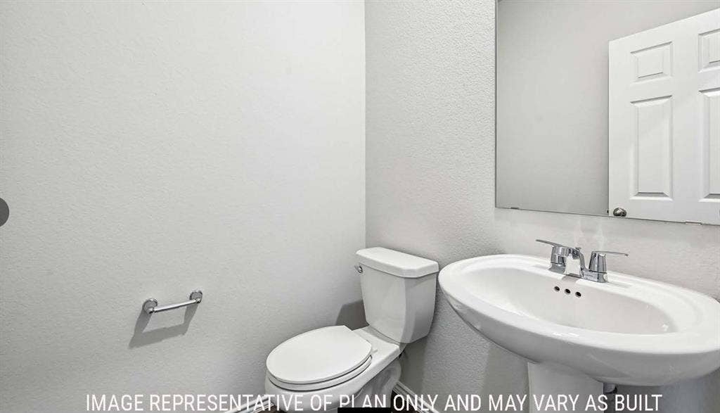 11813 Ceres Street, Lorena, TX 76655 Pedestal sink featuring a chrome faucet, wall-mounted mirror, and two-piece toilet