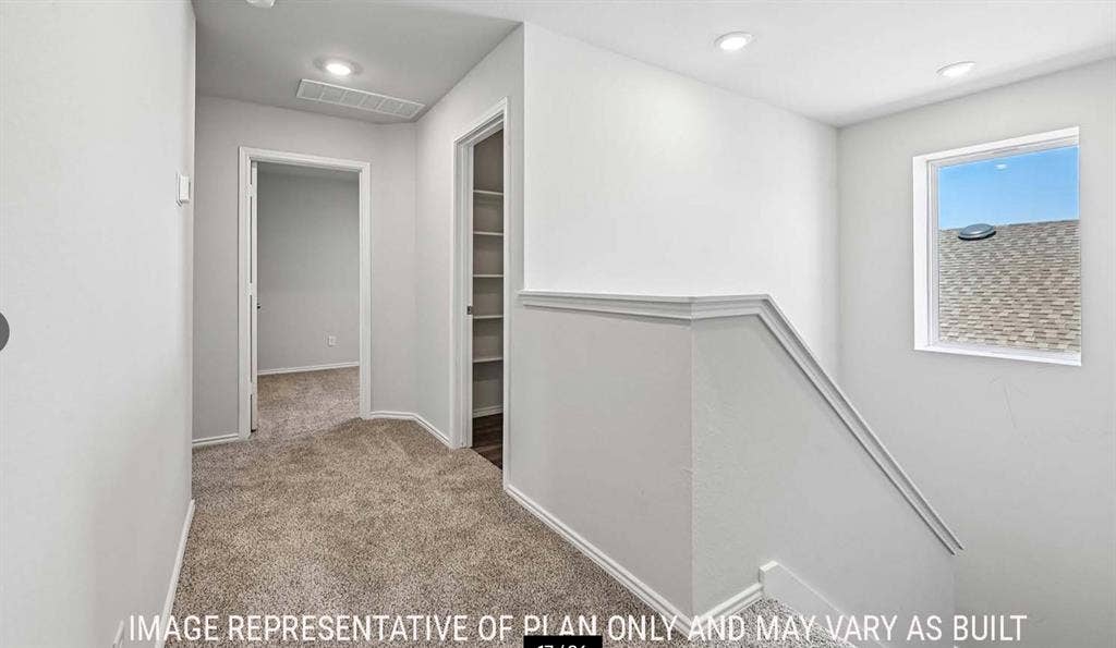 11813 Ceres Street, Lorena, TX 76655 Neutral-toned carpeted hallway featuring recessed lighting, a built-in linen storage closet with shelving, and a square window