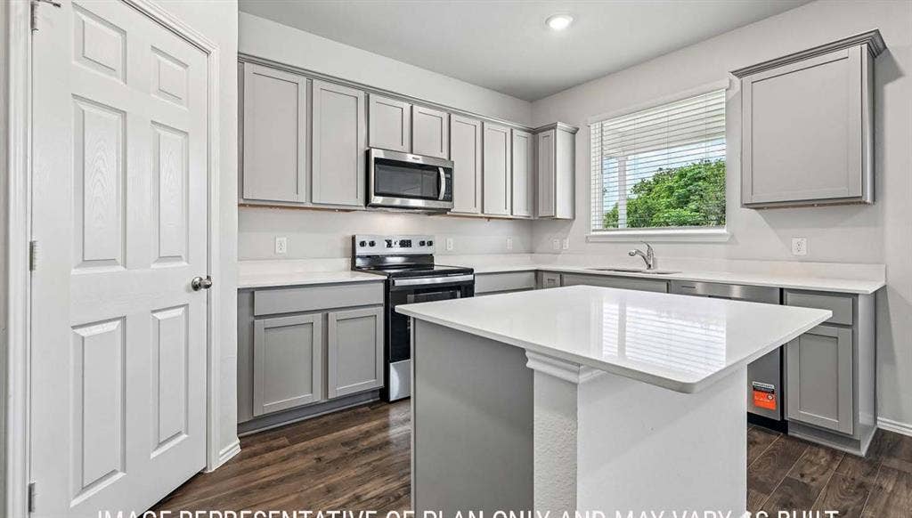 11813 Ceres Street, Lorena, TX 76655 Kitchen featuring gray cabinetry, solid-surface countertops, center island, stainless steel microwave, and wood-finish flooring