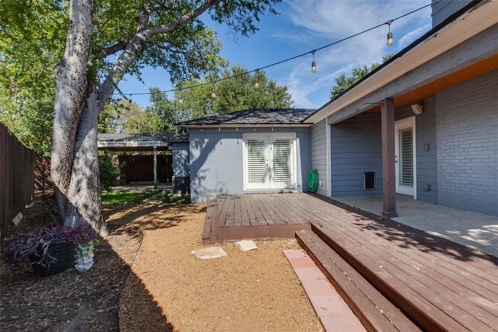 6507 Starling Circle, Dallas, TX 75209 Backyard deck and patio showing carport in background