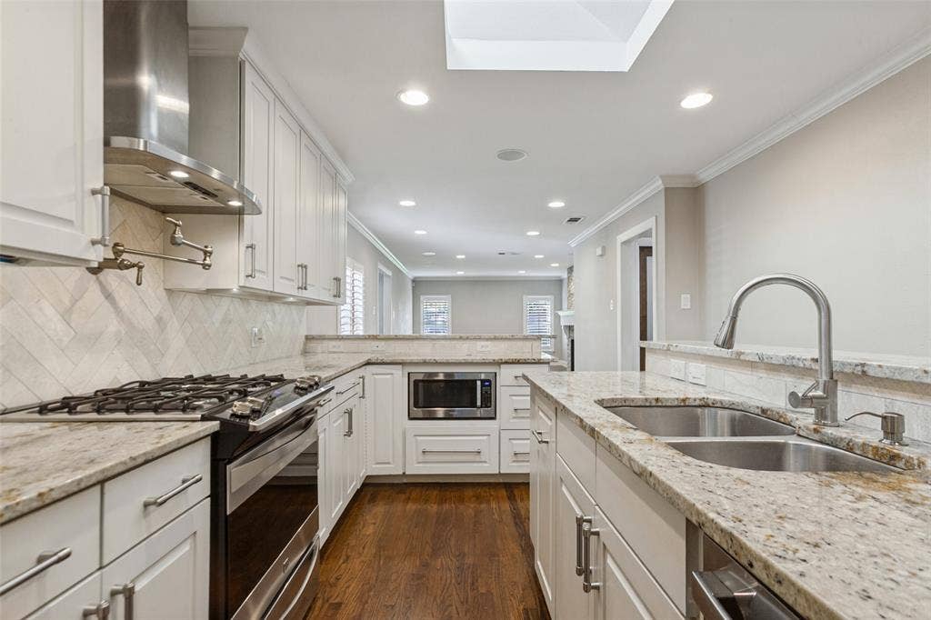 6507 Starling Circle, Dallas, TX 75209 Fully-equipped kitchen has stainless appliances, custom cabs, and granite countertops