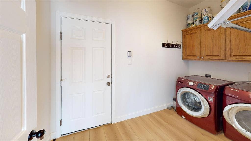 2254 Ash Grove Way, Dallas, TX 75228 Laundry room featuring wood-finish flooring, wall-mounted cabinetry, and a multi-hook rack