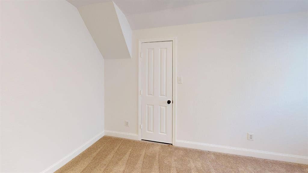 2254 Ash Grove Way, Dallas, TX 75228 Neutral-toned carpeted flooring, white interior walls, and a four-panel interior door with matte black hardware