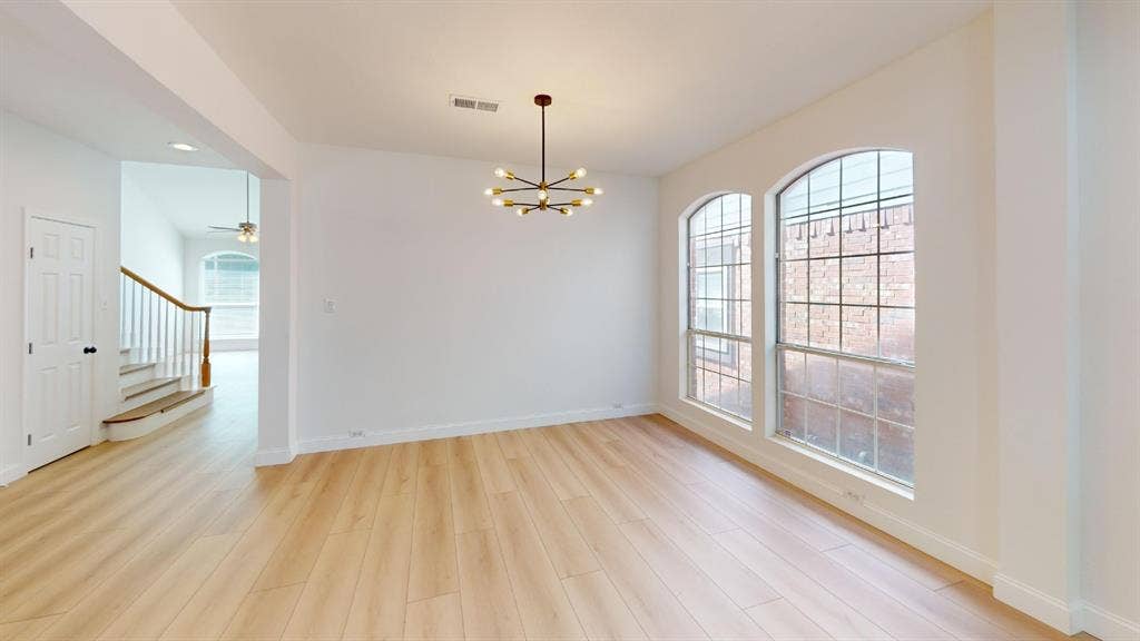 2254 Ash Grove Way, Dallas, TX 75228 Wood-finish flooring, multi-light modern chandelier, and arched grid windows