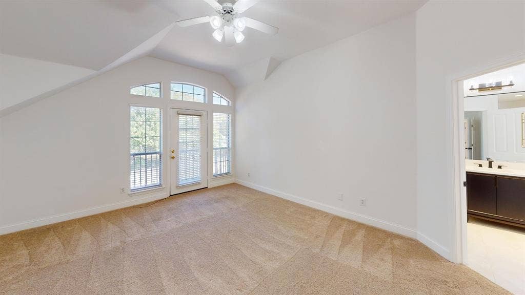 2254 Ash Grove Way, Dallas, TX 75228 Vaulted ceilings, carpeted flooring, multi-pane glass door with surrounding windows, and integrated ceiling fan
