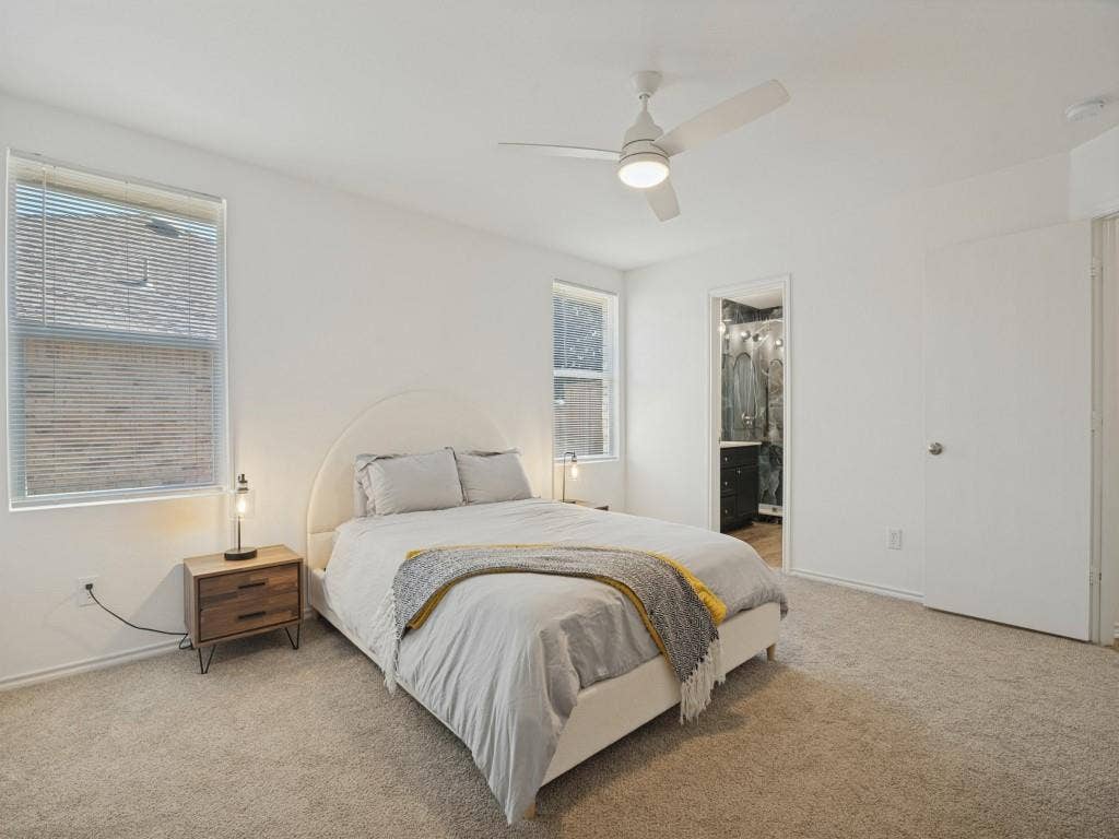 1728 Harvest Crossing Drive, Wylie, TX 75098 Neutral-toned carpeting, white walls, dual windows with blinds, and a white ceiling fan with integrated lighting