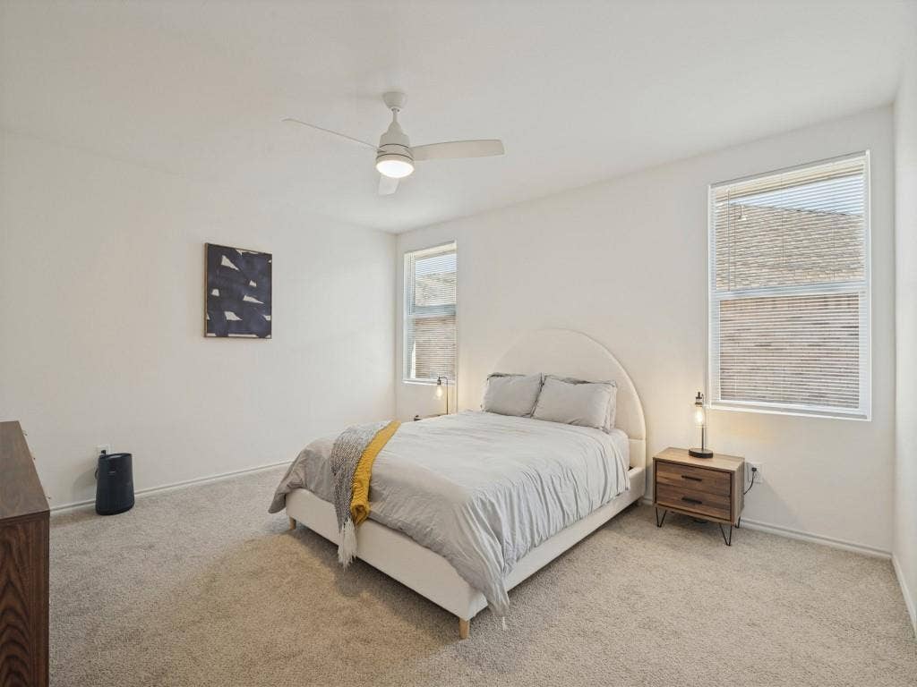 1728 Harvest Crossing Drive, Wylie, TX 75098 Neutral-toned carpeted flooring, dual windows with integrated blinds, and a white ceiling fan with an attached light fixture