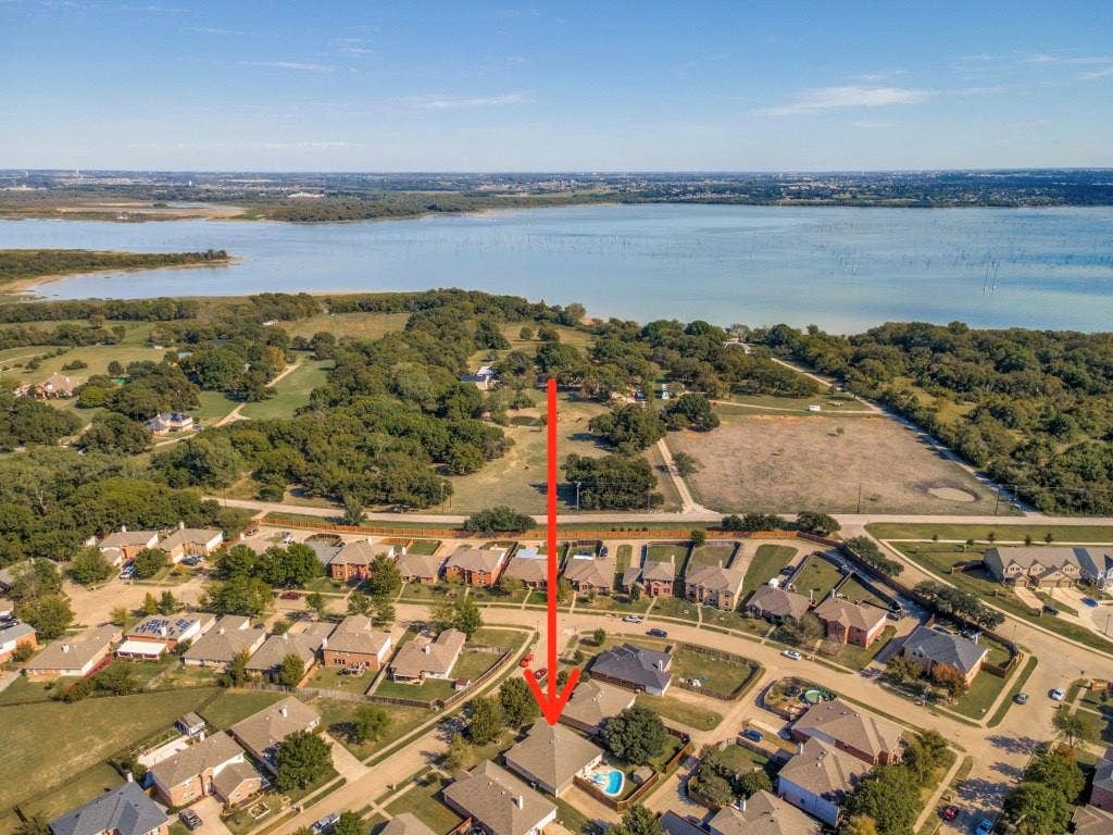 1728 Harvest Crossing Drive, Wylie, TX 75098 Aerial perspective featuring proximity to a large reservoir, expansive natural landscape, and residential setting with established vegetation