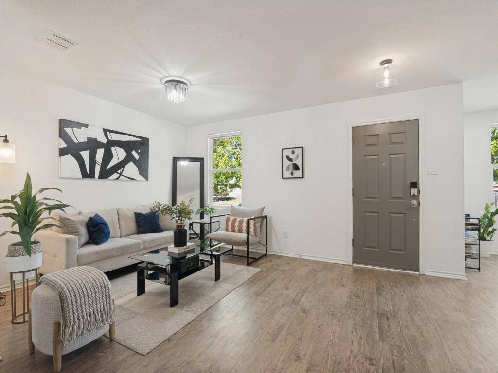 1728 Harvest Crossing Drive, Wylie, TX 75098 Wood-finish flooring, neutral wall palette, multi-paneled entry door, crystal-accent flush mount lighting, and recessed ceiling lighting