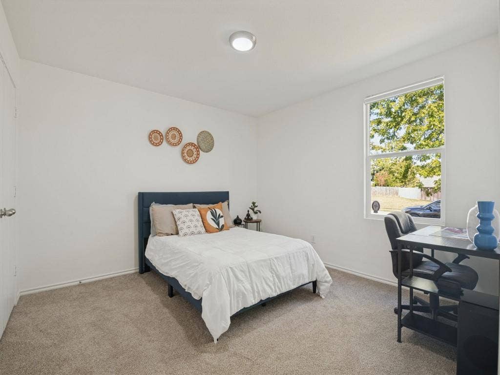 1728 Harvest Crossing Drive, Wylie, TX 75098 Neutral-toned carpeting, high-gloss white walls, single-hung window with exterior greenery, flush-mount ceiling light fixture, and interior door with brushed metal hardware