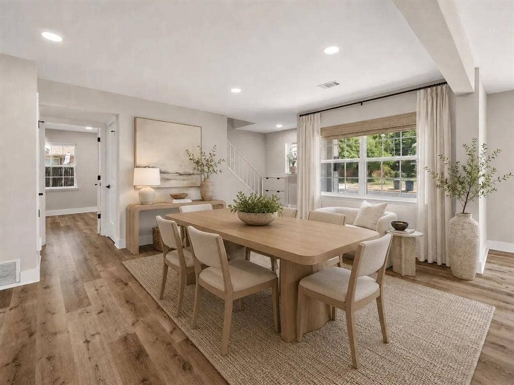 Dining area featuring wood-finish flooring, recessed lighting, and a multi-pane window with natural light