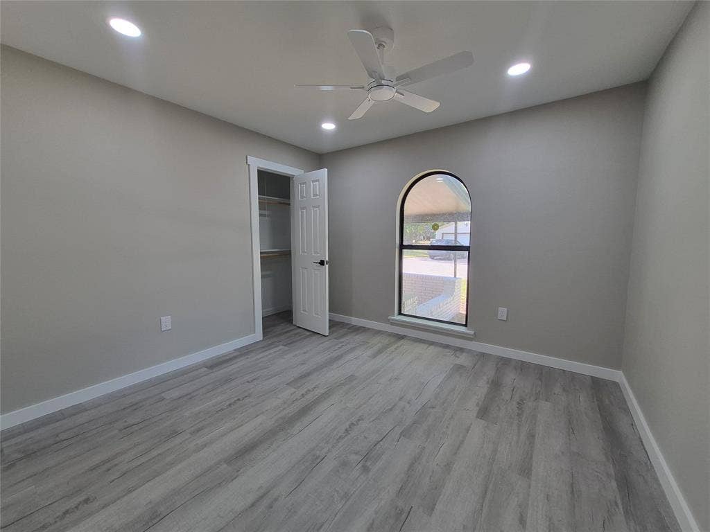2029 Roberts Drive, Granbury, TX 76048 Interior space featuring wood-finish flooring, an arched window, recessed lighting, and a ceiling fan