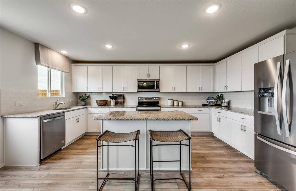 1056 Clear Dusk Lane, Forney, TX 75126 *Model Representation - Spacious kitchen with eat-in bartop island