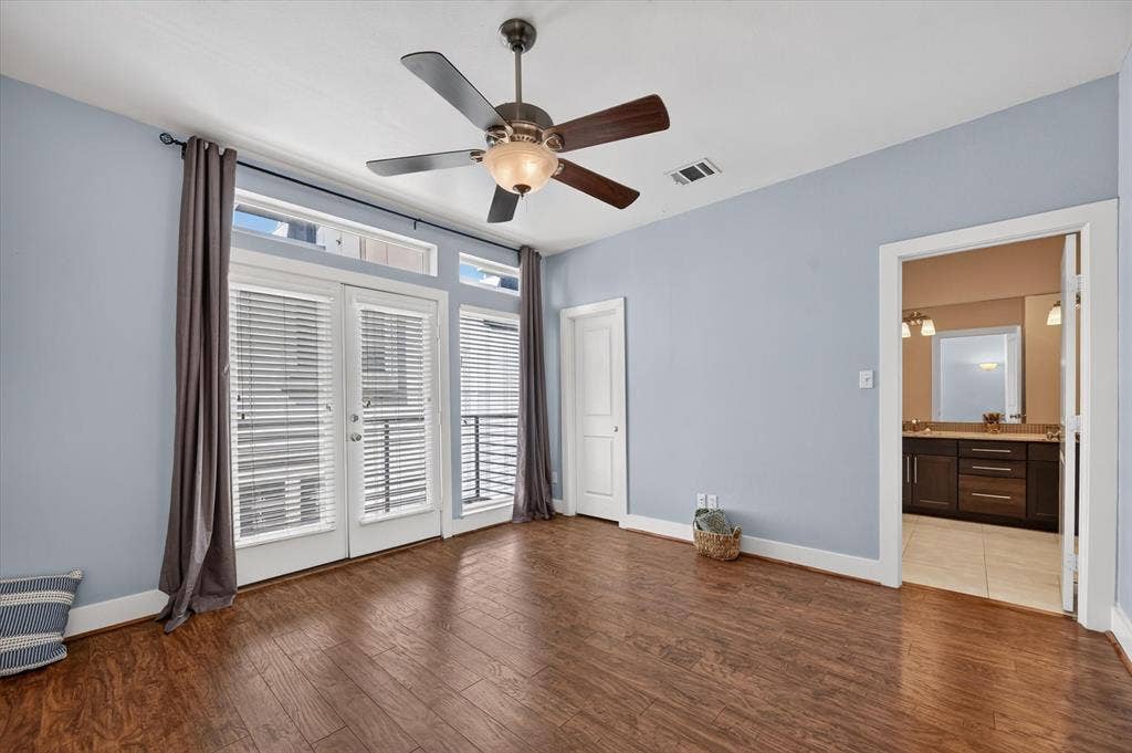Large primary suite with doors to another balcony