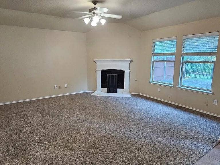 1000 Buffalo Creek Drive, McKinney, TX 75072 Vaulted ceilings, fireplace with a white mantel, neutral carpeting, and large windows with blinds