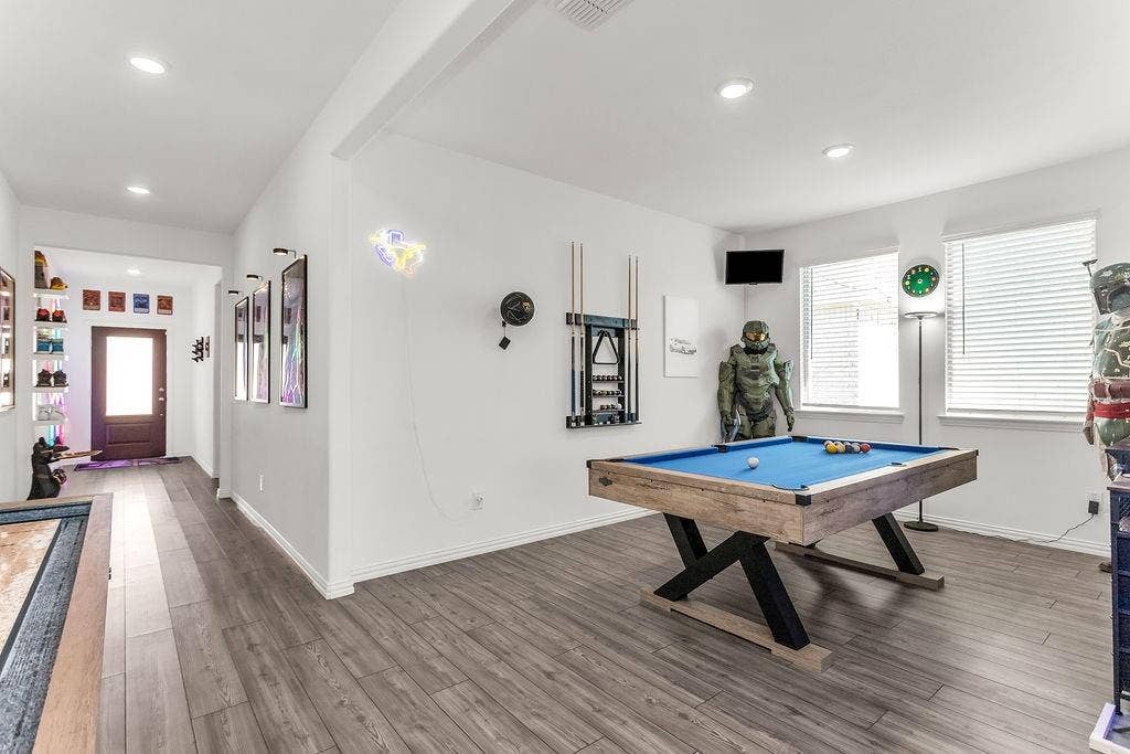 Open-concept interior featuring vinyl flooring, recessed lighting, and windows with horizontal blinds