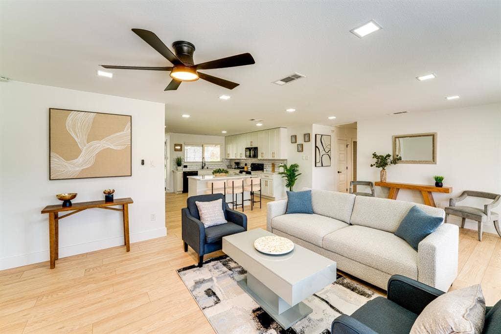 Open-concept living space featuring wood-finish flooring, recessed lighting, and a modern ceiling fan