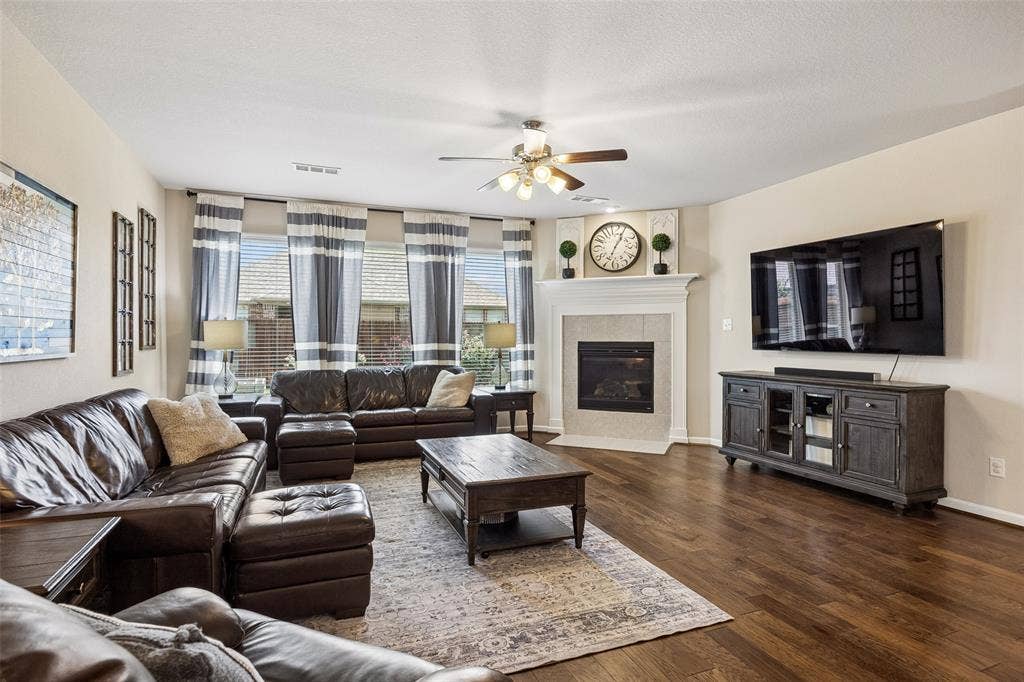 1321 Meridian Drive, Forney, TX 75126 Spacious living area featuring a ceiling fan and fireplace