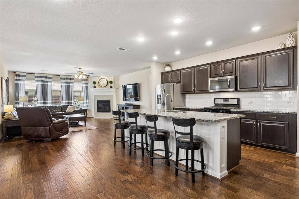 1321 Meridian Drive, Forney, TX 75126 Open-concept living area and kitchen featuring a kitchen island with seating