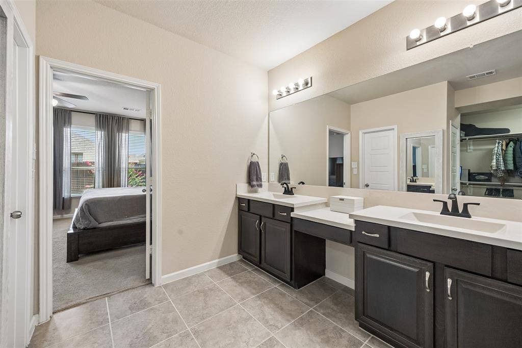 1321 Meridian Drive, Forney, TX 75126 The large vanity features 2 sinks and a lower vanity sitting area.
