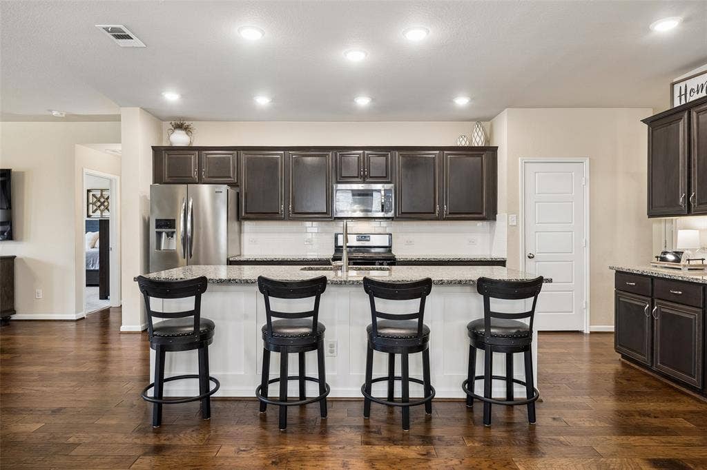 1321 Meridian Drive, Forney, TX 75126 The oversized island has breakfast bar seating and a sink.