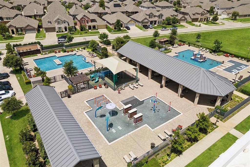 1321 Meridian Drive, Forney, TX 75126 Community amenity center featuring multiple pools, a shaded play structure, and a dedicated splash pad