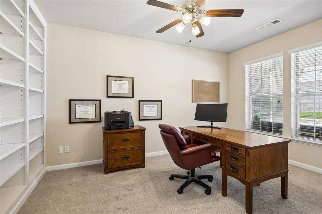 1321 Meridian Drive, Forney, TX 75126 Dedicated home office with extensive built-in shelving and a ceiling fan