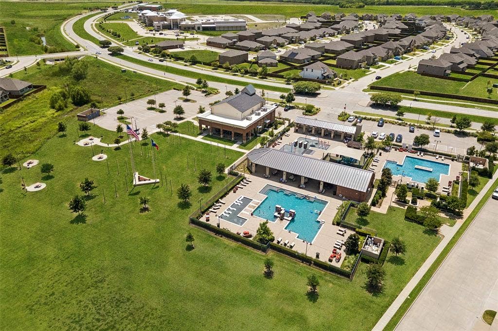 1321 Meridian Drive, Forney, TX 75126 Community recreation area featuring multiple swimming pools, a covered outdoor lounge, and surrounding green spaces