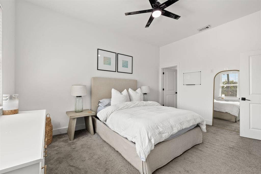 2502 Elsie Faye Heggins Street, Dallas, TX 75215 Vaulted ceiling, neutral wall-to-wall carpeting, and matte black ceiling fan with integrated lighting