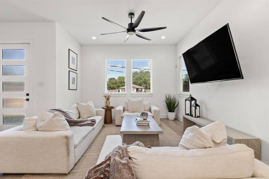 2502 Elsie Faye Heggins Street, Dallas, TX 75215 Living area featuring neutral wall paint, multi-paned glass exterior door, recessed lighting, matte black ceiling fan, and double-pane windows