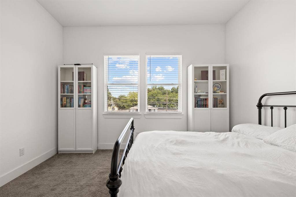 2502 Elsie Faye Heggins Street, Dallas, TX 75215 Bedroom with neutral carpeting, white walls, and two dual-pane windows providing natural light