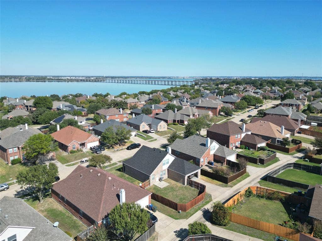 4102 Maidstone Drive, Garland, TX 75043 Neighborhood aerial panorama showing surrounding homes and streets, with a large body of water visible beyond the rooftops.