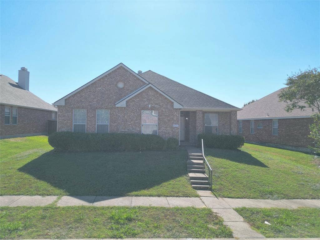 4102 Maidstone Drive, Garland, TX 75043 Straight-on front exterior view showing the brick facade, roofline, front lawn, and walkway to the entrance.