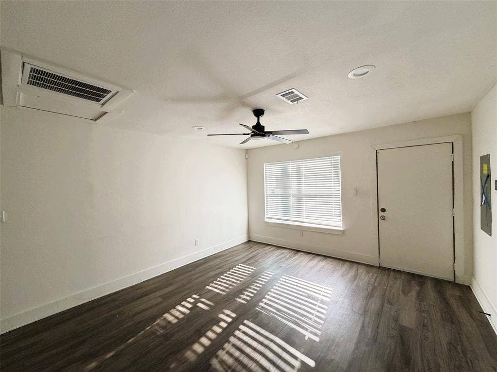 Living room with entry open to kitchen and dining.
