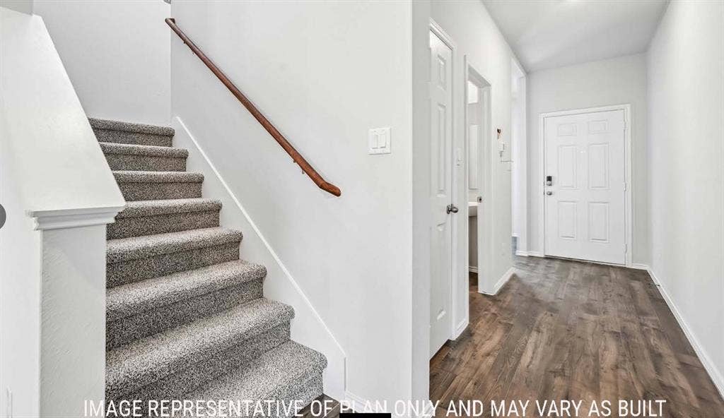 11709 Ceres Street, Lorena, TX 76655 Entryway featuring wood-finish flooring, a carpeted staircase with a wood handrail, and a six-panel front door