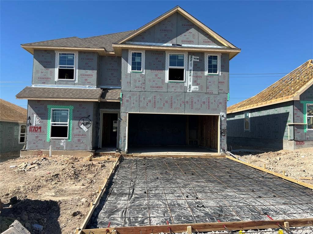 11709 Ceres Street, Lorena, TX 76655 Two-story residential structure featuring a gable roof, integrated two-car garage, and installed multi-pane windows