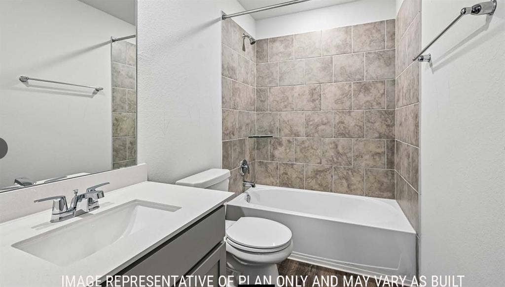 11709 Ceres Street, Lorena, TX 76655 Full-width mirror, vanity with a white countertop and undermount sink, shower-tub combination with full-height tile surround, and wood-finish flooring