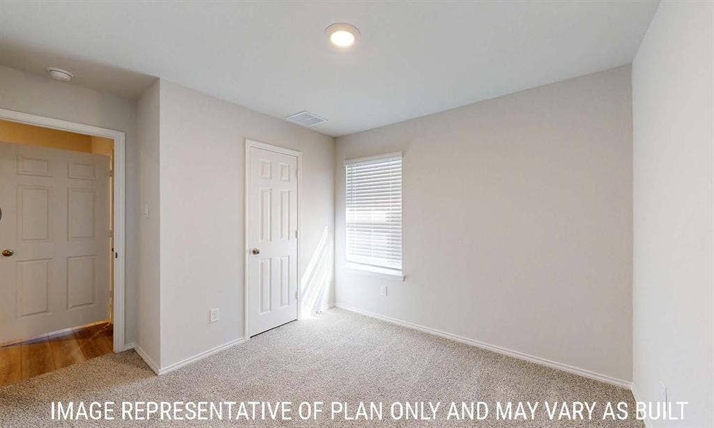 3213 Cyprian Road, Lorena, TX 76655 Neutral wall-toned room featuring carpeted flooring, a six-panel interior door, a single-hung window with horizontal blinds, and a flush-mount ceiling light fixture