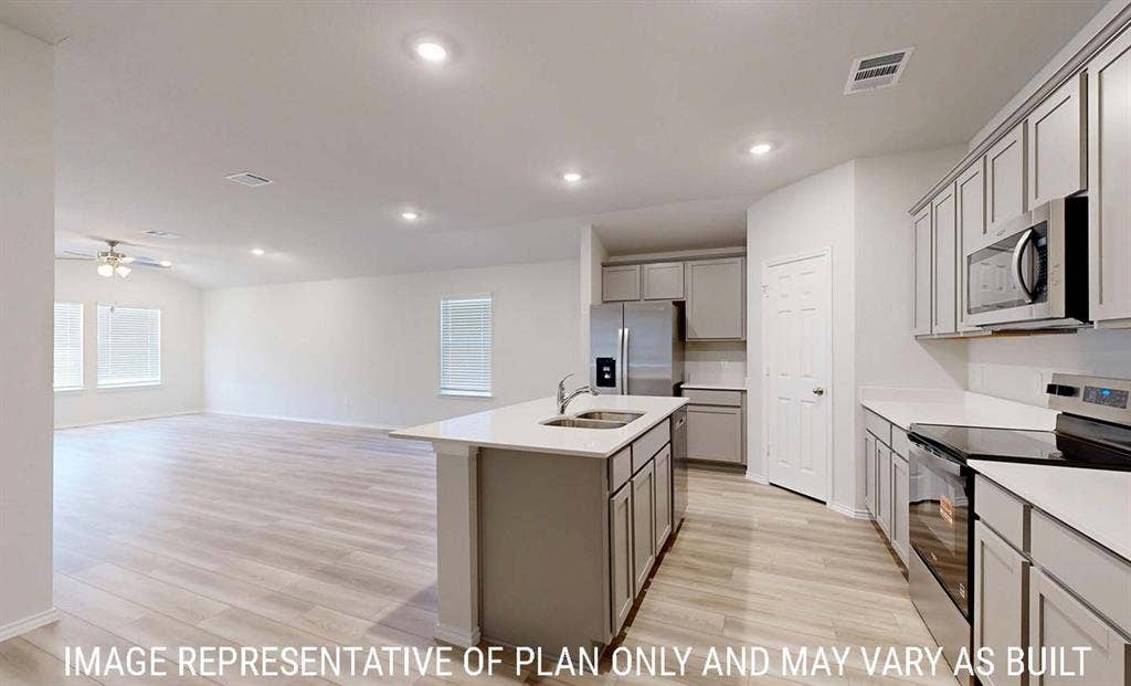 3213 Cyprian Road, Lorena, TX 76655 Kitchen featuring a center island, light-toned cabinetry, stainless steel appliances, and wood-finish flooring with recessed lighting
