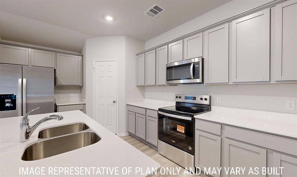 3213 Cyprian Road, Lorena, TX 76655 Kitchen featuring light grey shaker-style cabinetry, white quartz countertops, stainless steel appliances, and a dual-basin undermount sink with a gooseneck faucet