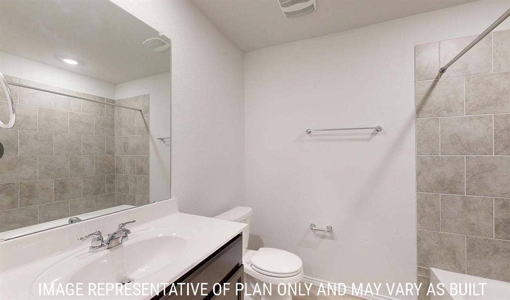 3213 Cyprian Road, Lorena, TX 76655 Bathroom featuring a dark-finish vanity with a white countertop, large wall-mounted mirror, and a tub with a grey tile surround