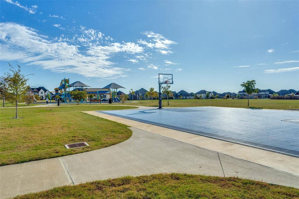 Community park with open green space, basketball and a playground.