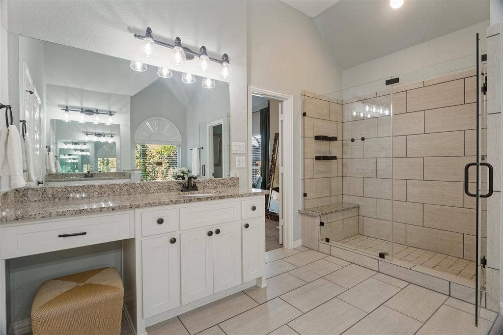 Oversized shower with a built-in bench, and a makeup bench.