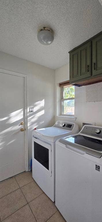 Laundry space featuring tile flooring, neutral-toned wall cabinetry, and a window providing natural light