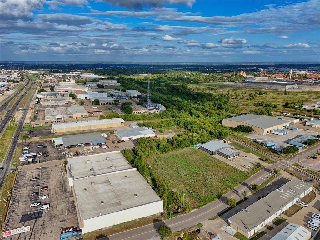 TBD Schroeder Drive, Waco, TX 76710 Aerial perspective featuring expansive undeveloped land parcel with frontage on a paved thoroughfare, surrounded by established industrial and commercial infrastructure
