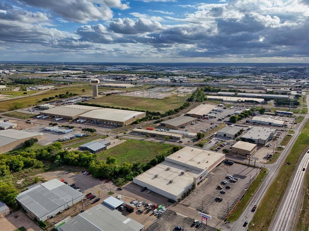 TBD Schroeder Drive, Waco, TX 76710 Aerial perspective of industrial complex featuring expansive paved parking lots, multi-bay warehouse structures, metal roof systems, and proximity to regional transportation infrastructure