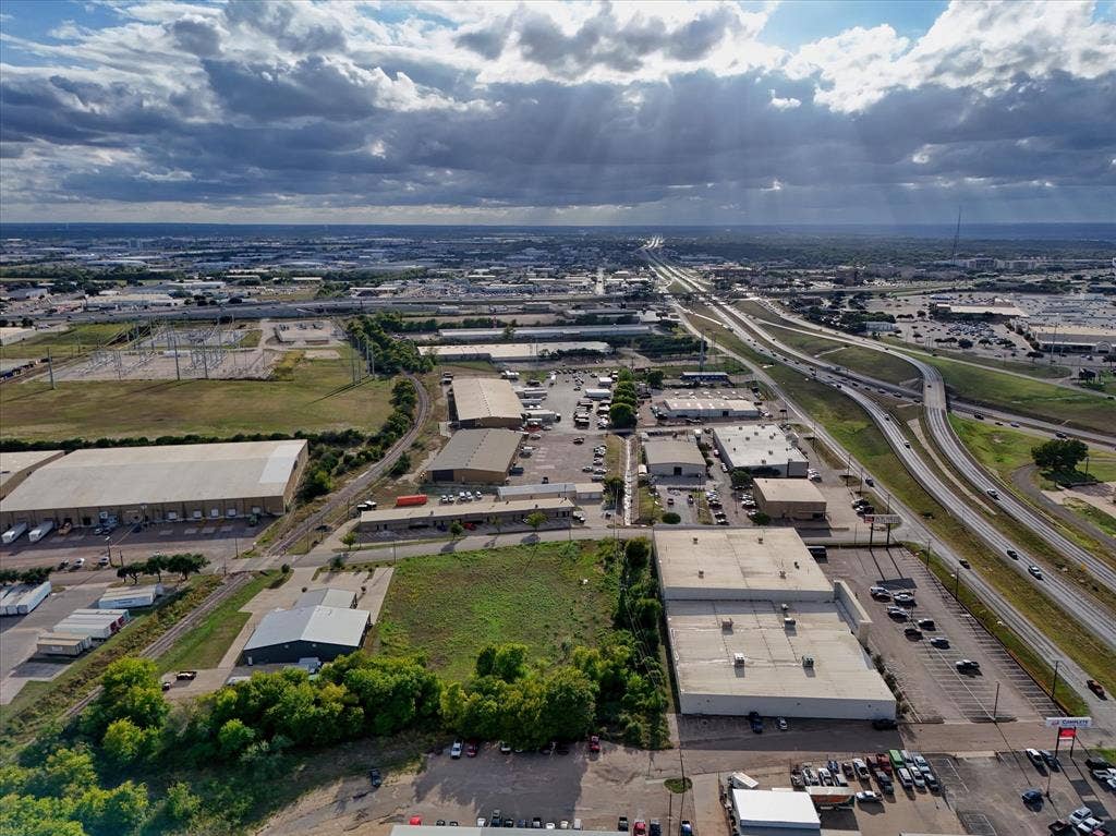 TBD Schroeder Drive, Waco, TX 76710 Aerial view of a commercial site featuring multiple industrial structures, paved parking areas, and frontage along a major highway