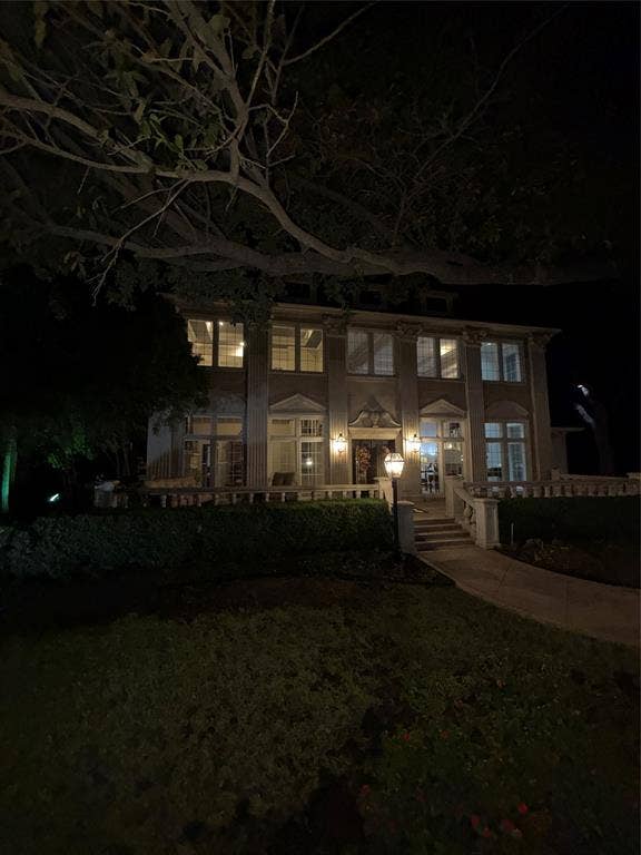 3011 Country Club Drive, McKinney, TX 75070 Two-story residence featuring a columned facade, stone balustrade terrace, multipane windows, and an arched entryway