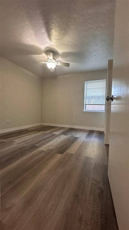 1217 Cloverdale Drive, Richardson, TX 75080 Neutral-toned room featuring multi-tonal wood-finish flooring, a ceiling fan with integrated lighting, and a single-pane window