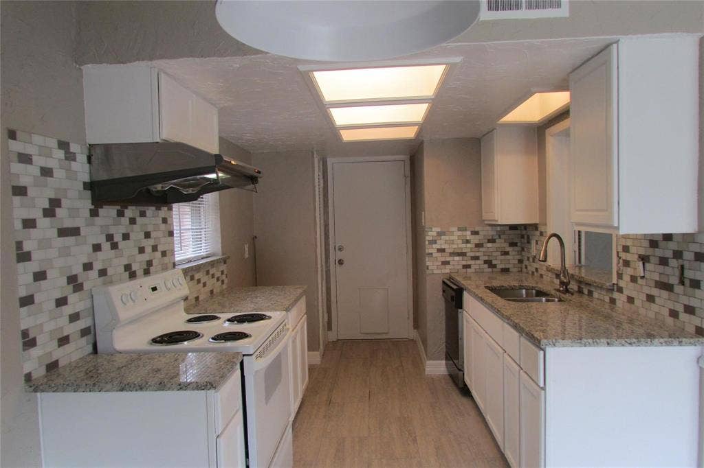 1217 Cloverdale Drive, Richardson, TX 75080 Kitchen featuring white cabinetry, stone-finish countertops, mosaic tile backsplash, wood-finish flooring, and recessed ceiling lighting